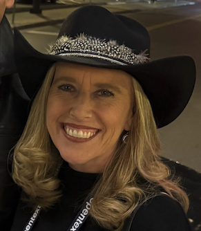 Erin McCabe smiling in a cowboy hat